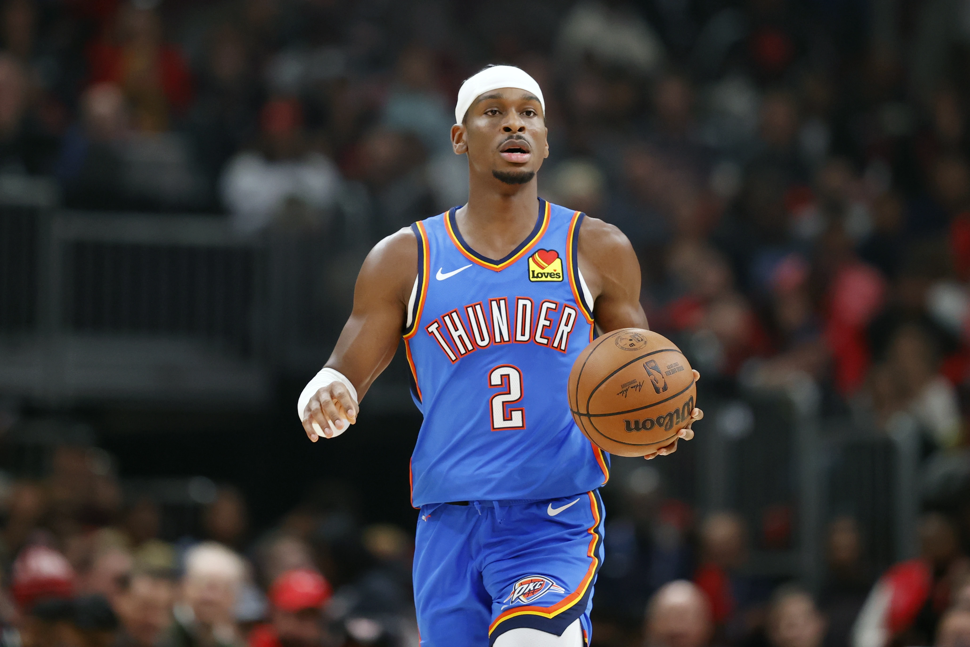 Oklahoma City Thunder guard Shai Gilgeous-Alexander (2) brings the ball up court against the Chicago Bulls during the second half of a basketball game at United Center.