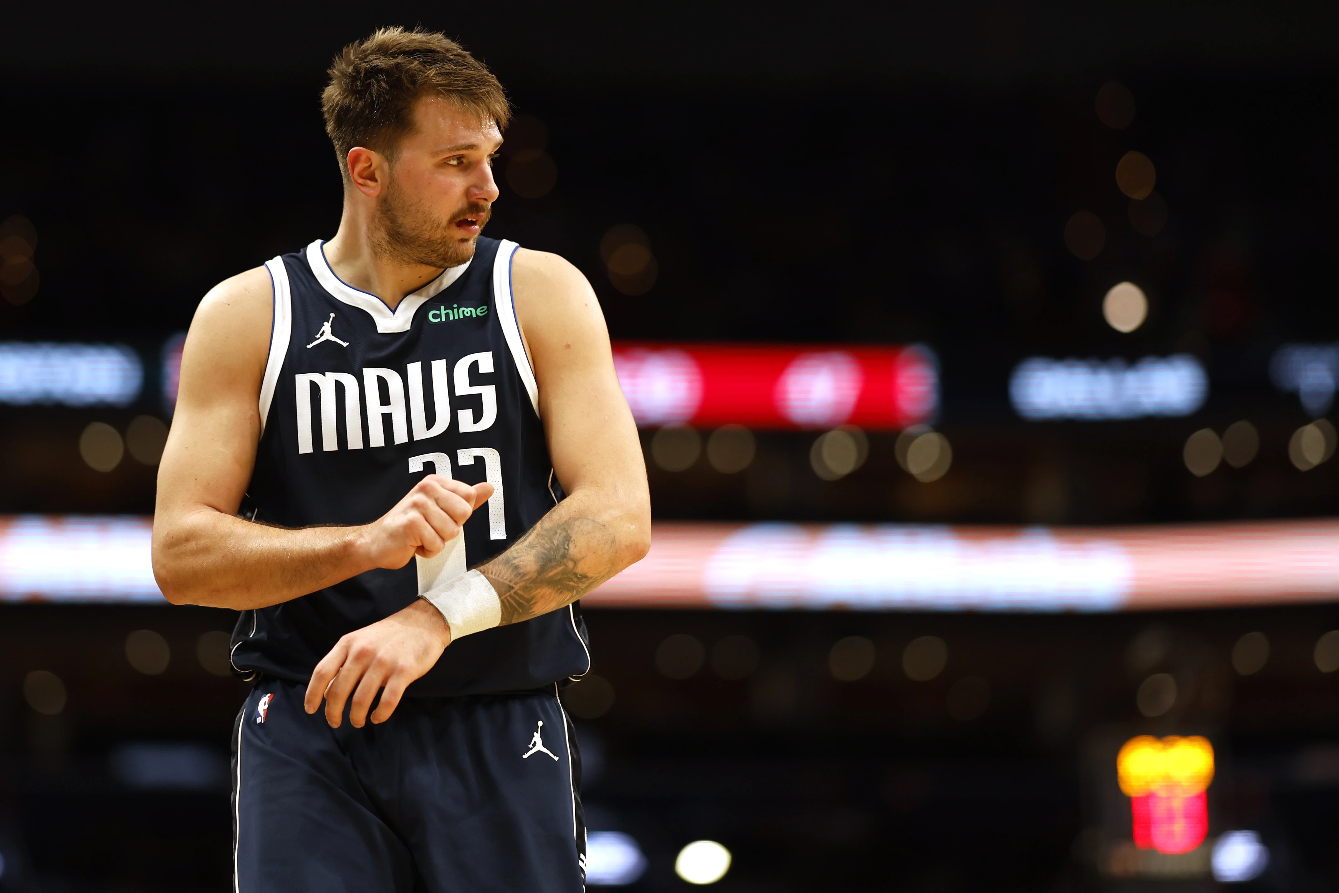 Dallas Mavericks guard Luka Doncic (77) adjusts a wrist wrap against the Washington Wizards in the second quarter at Capital One Arena.