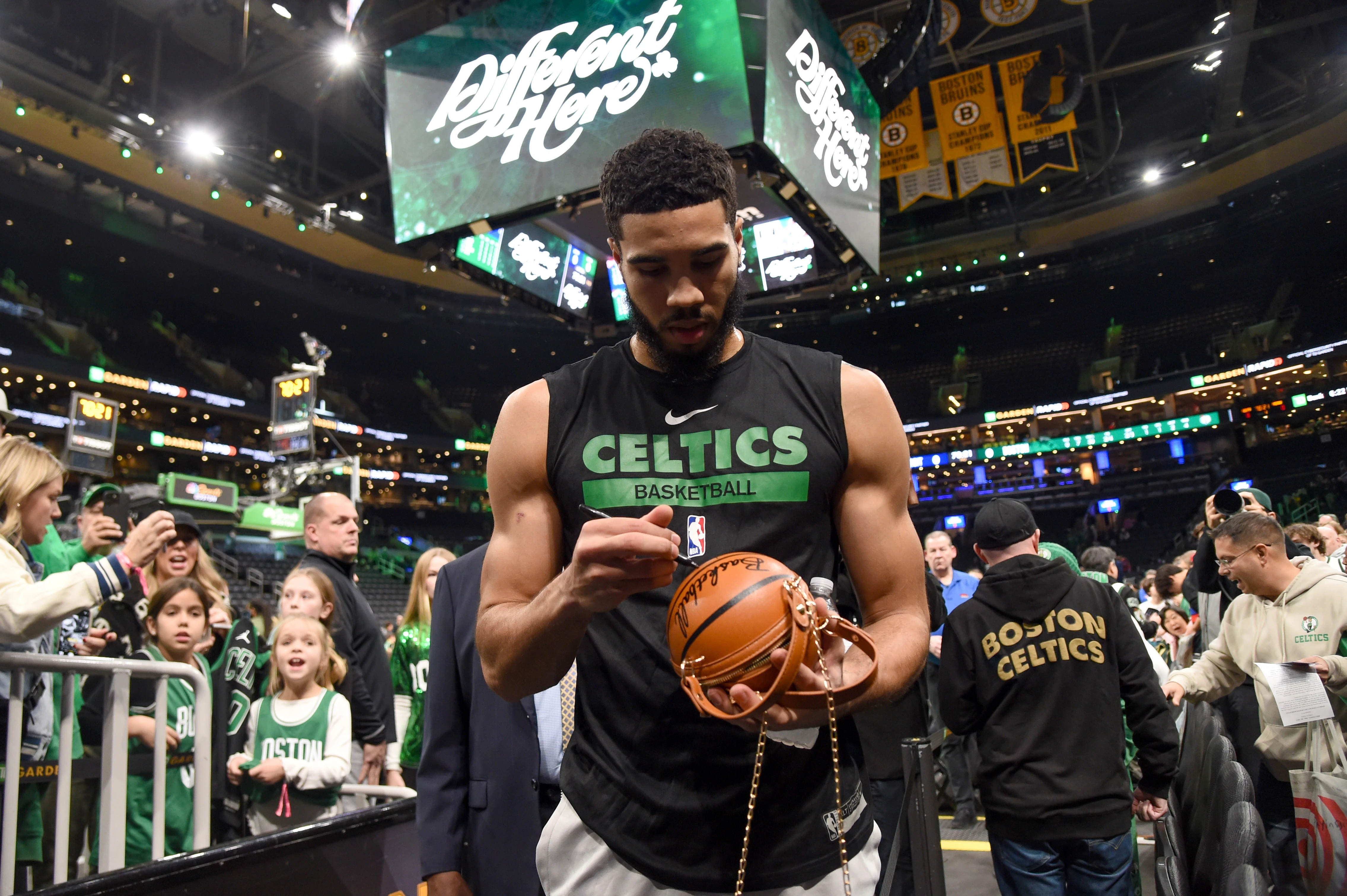 Boston Celtics forward Jayson Tatum (0) signs an autograph prior to a game against the Detroit Pistons at TD Garden.