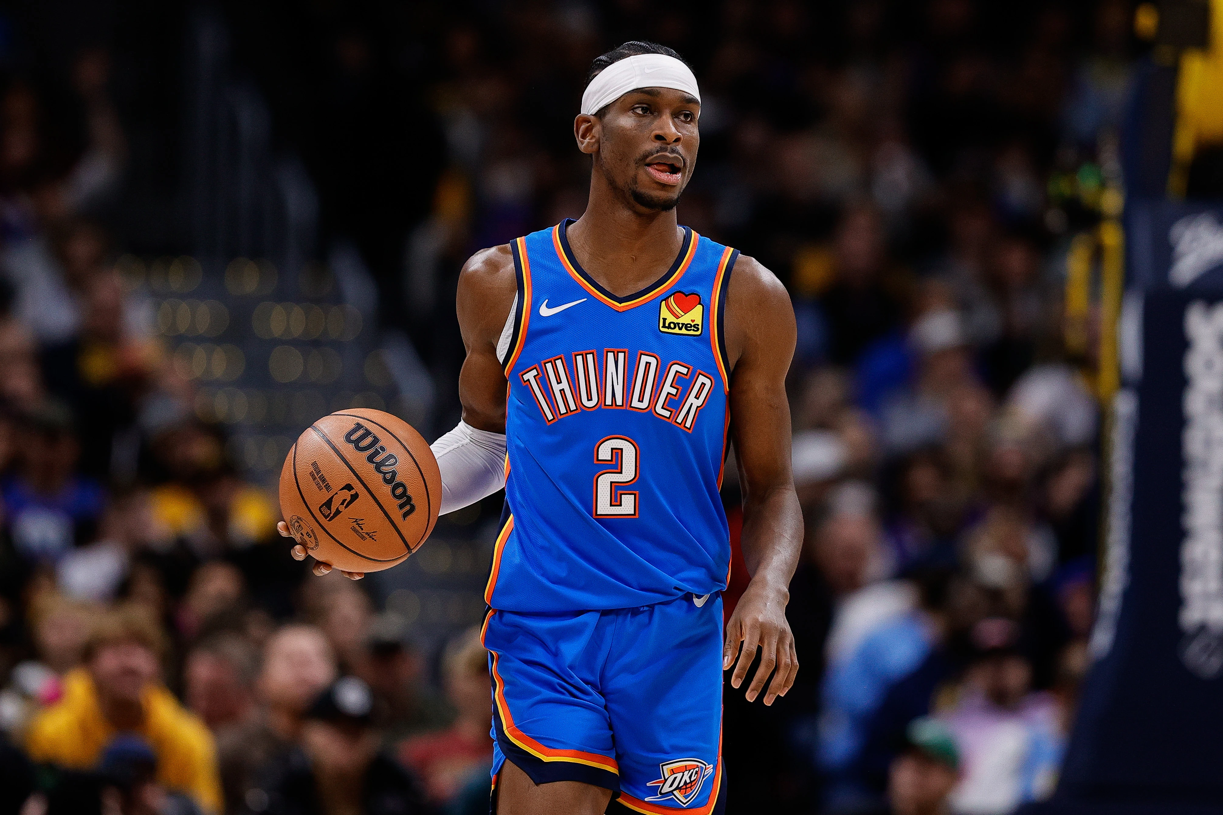 Oklahoma City Thunder guard Shai Gilgeous-Alexander (2) dribbles the ball up court in the first quarter against the Denver Nuggets at Ball Arena.