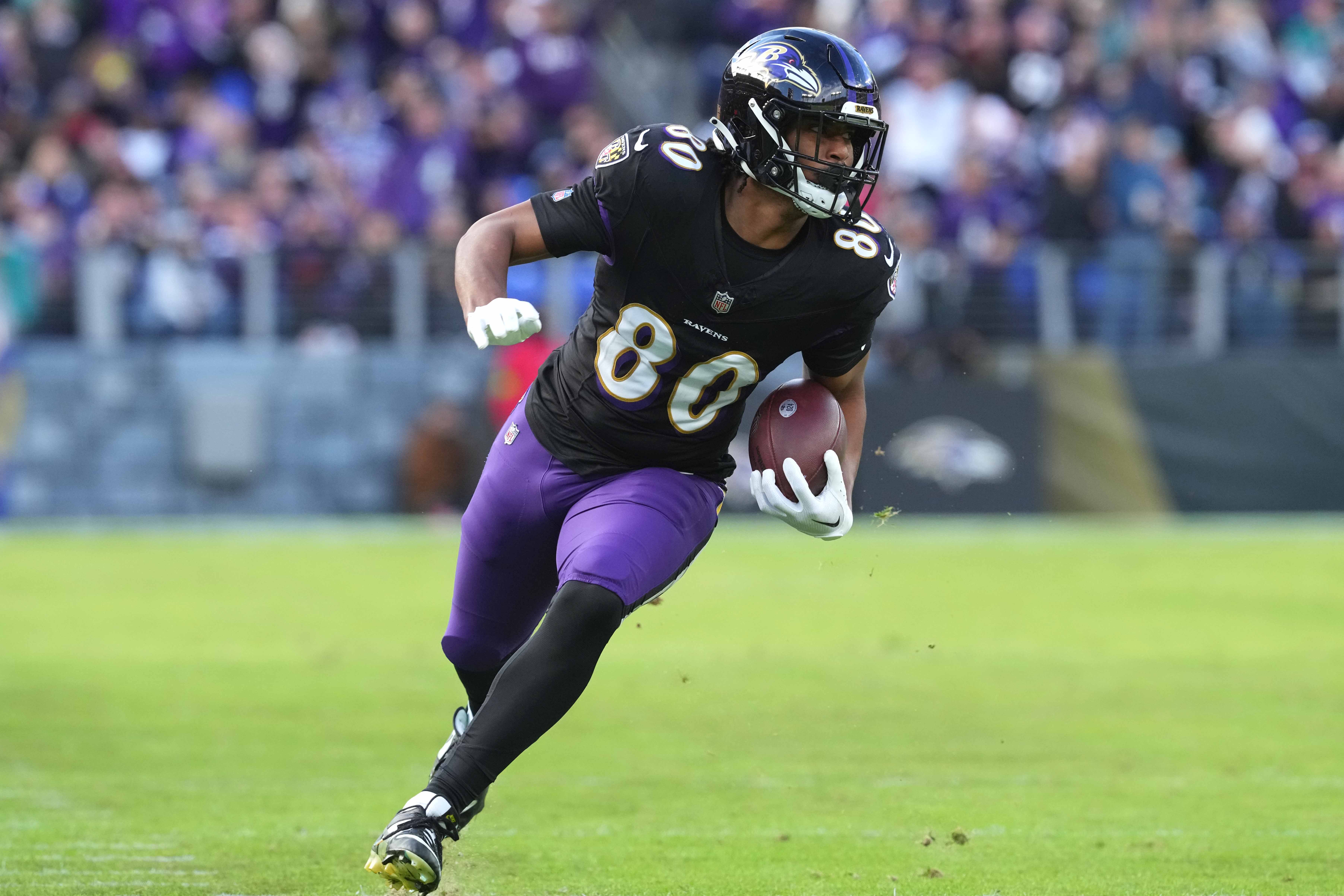 Dec 31, 2023; Baltimore, Maryland, USA; Baltimore Ravens tight end Isaiah Likely (80) runs following his catch for a second quarter touchdown against the Miami Dolphins at M&T Bank Stadium.