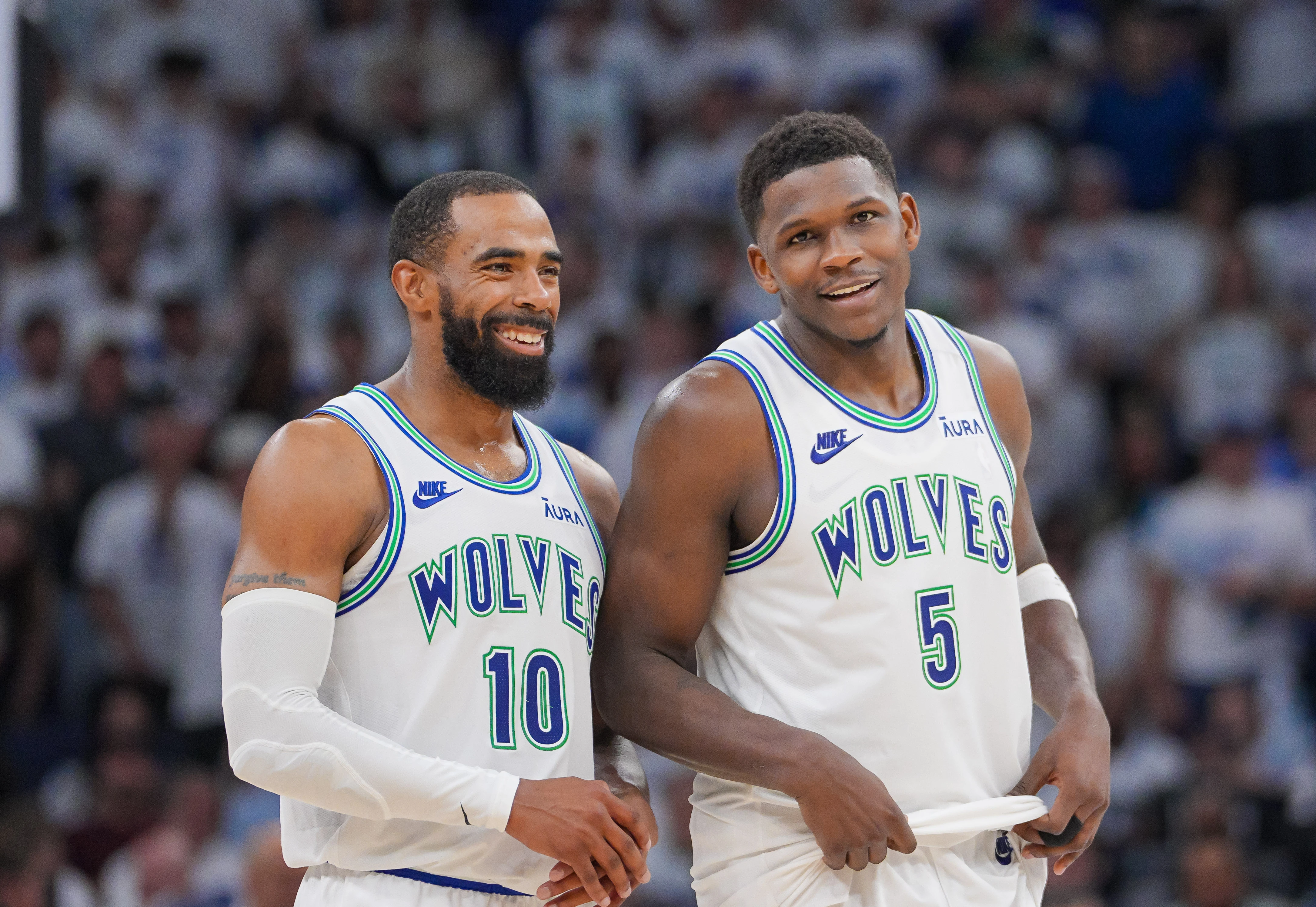 Minnesota Timberwolves guard Mike Conley (10) and guard Anthony Edwards (5) talk against the Denver Nuggets in the fourth quarter during game six of the second round for the 2024 NBA playoffs at Target Center.