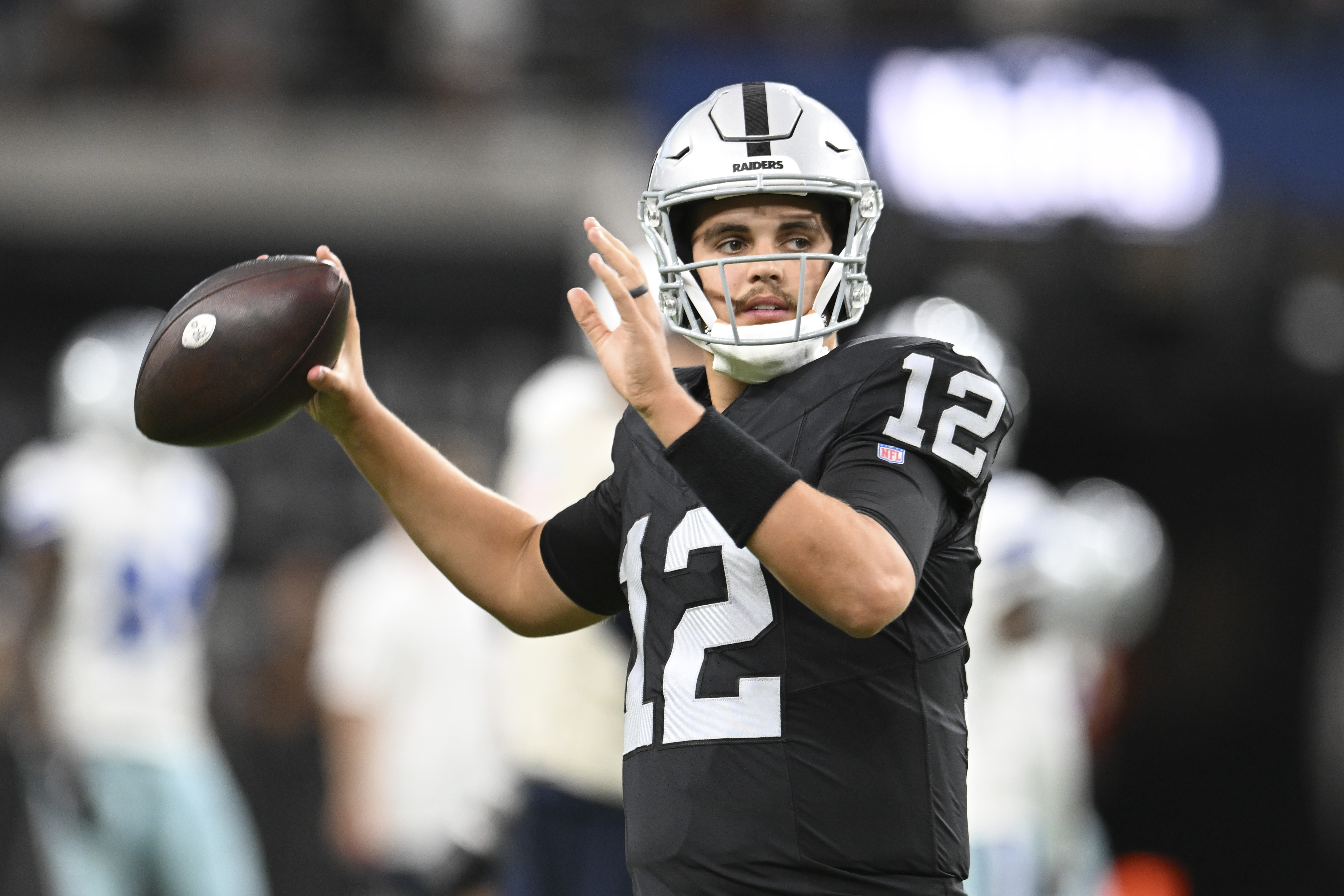 Aug 17, 2024; Paradise, Nevada, USA; Las Vegas Raiders quarterback Aidan O'Connell (12) warms up against the Dallas Cowboys at Allegiant Stadium.