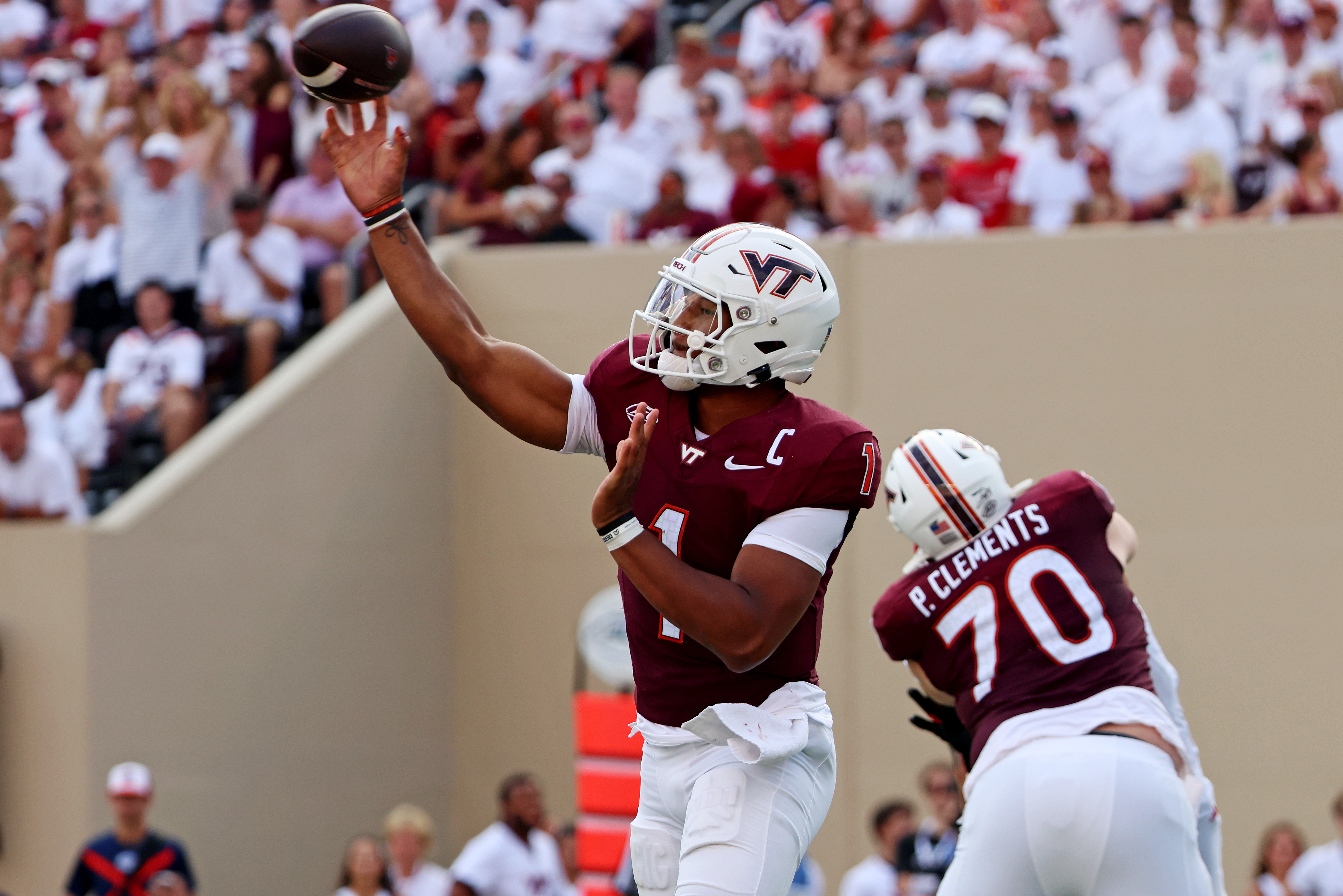 Sep 21, 2024; Blacksburg, Virginia, USA; Virginia Tech Hokies quarterback Kyron Drones (1) throws a pass during the third quarter against the Rutgers Scarlet Knights at Lane Stadium.