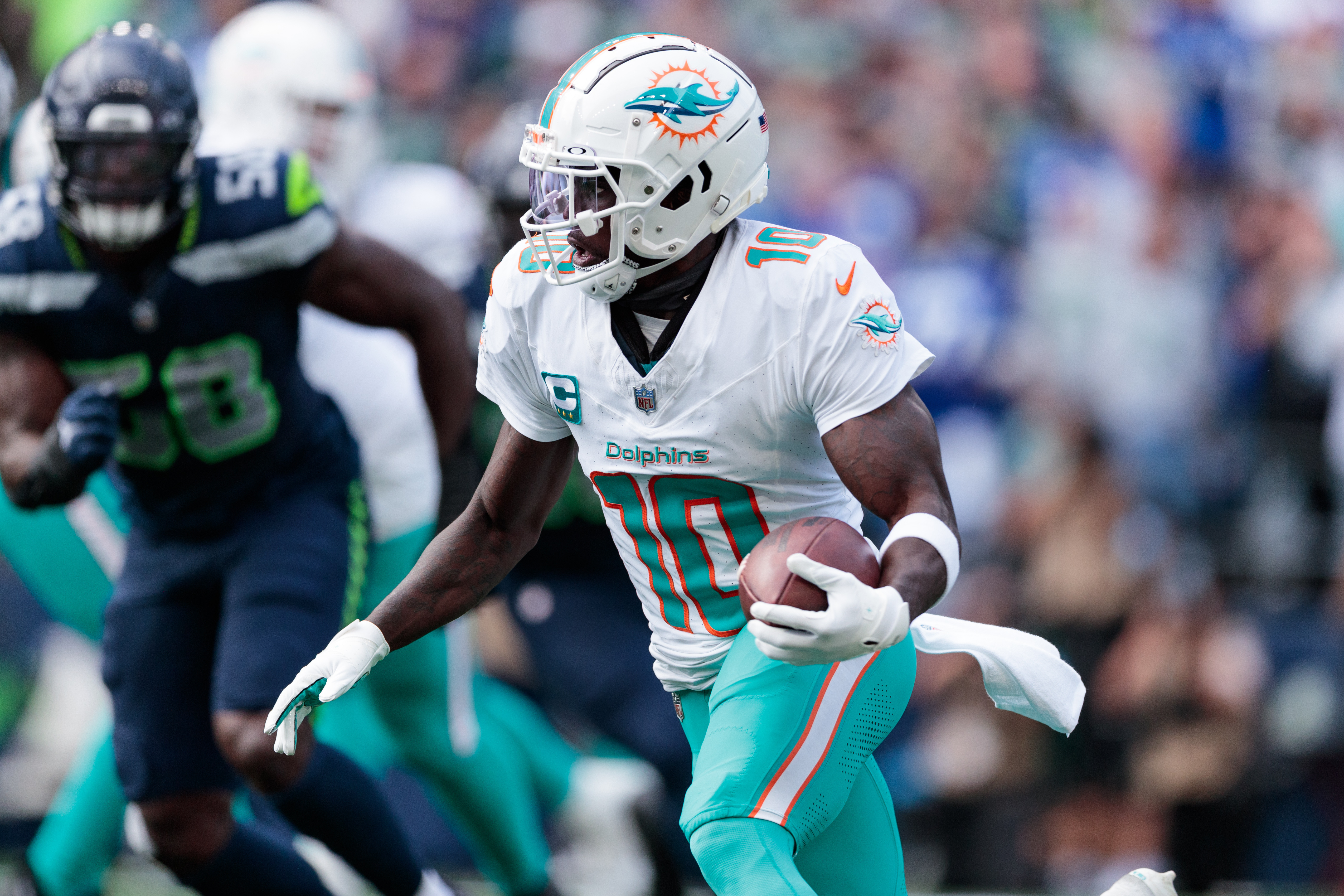 Sep 22, 2024; Seattle, Washington, USA; Miami Dolphins wide receiver Tyreek Hill (10) runs with the ball during the third quarter against Seattle Seahawks at Lumen Field.