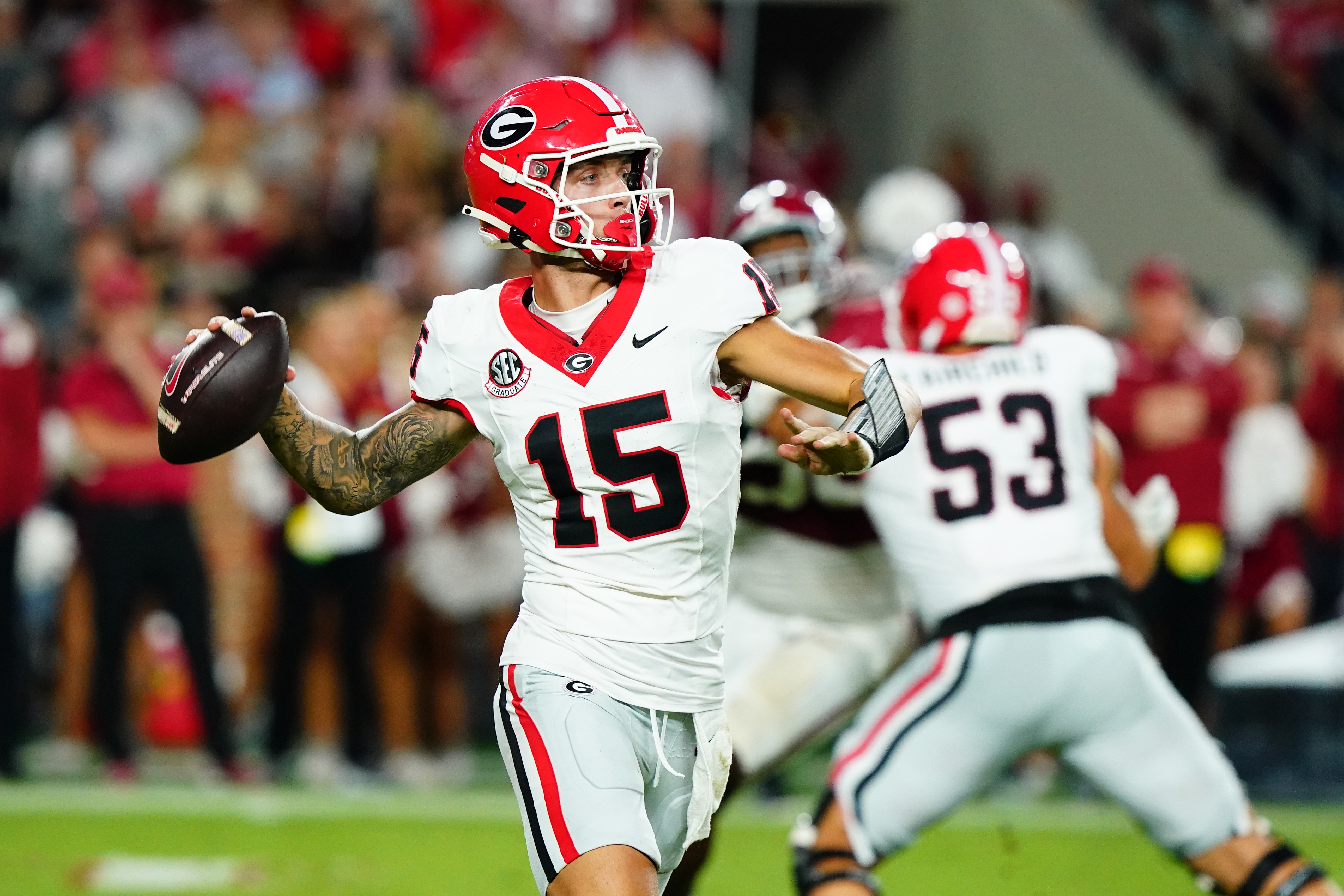 Sep 28, 2024; Tuscaloosa, Alabama, USA; Georgia Bulldogs quarterback Carson Beck (15) rolls out to throw against the Alabama Crimson Tide during the third quarter at Bryant-Denny Stadium.