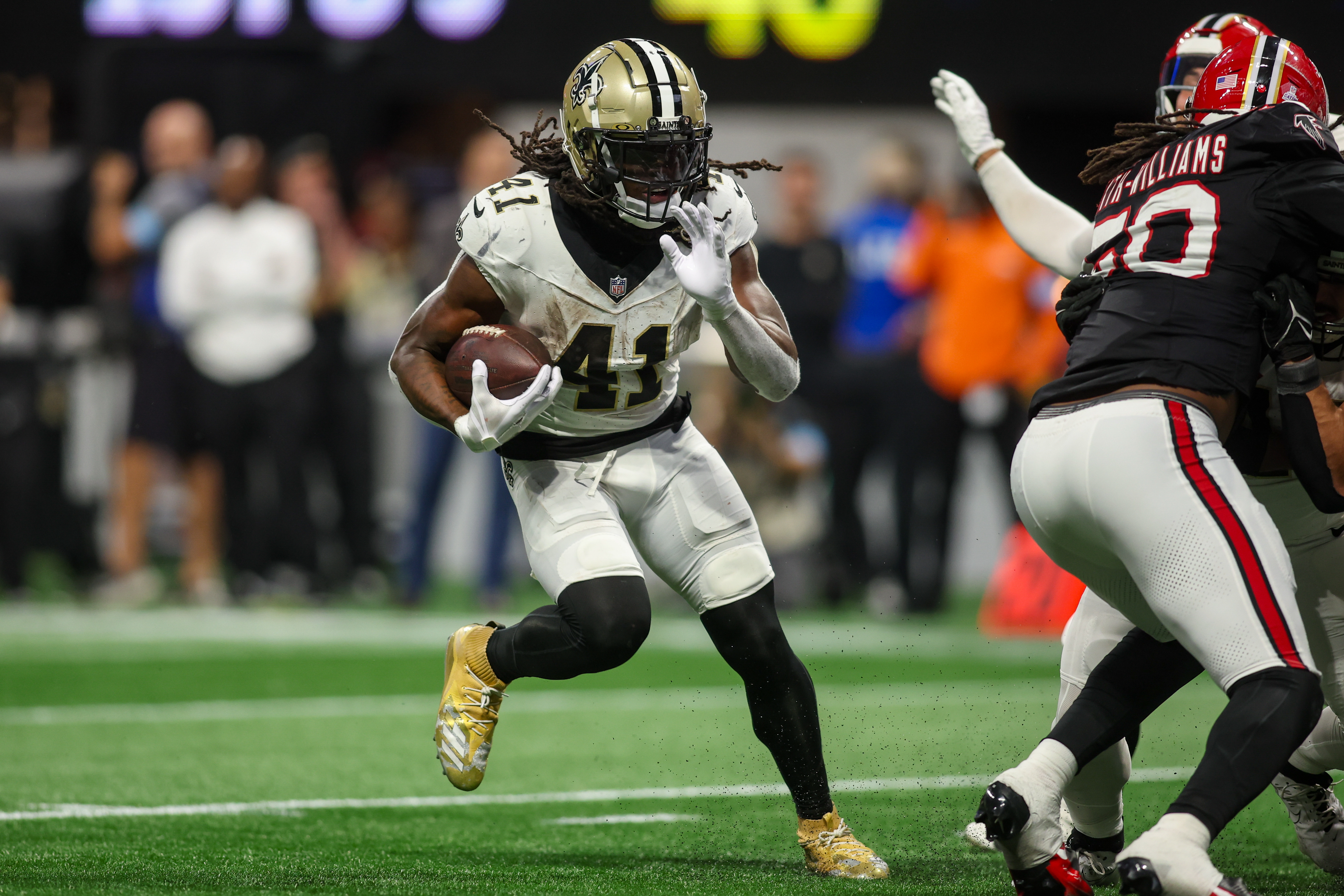 Sep 29, 2024; Atlanta, Georgia, USA; New Orleans Saints running back Alvin Kamara (41) runs the ball against the Atlanta Falcons in the fourth quarter at Mercedes-Benz Stadium.