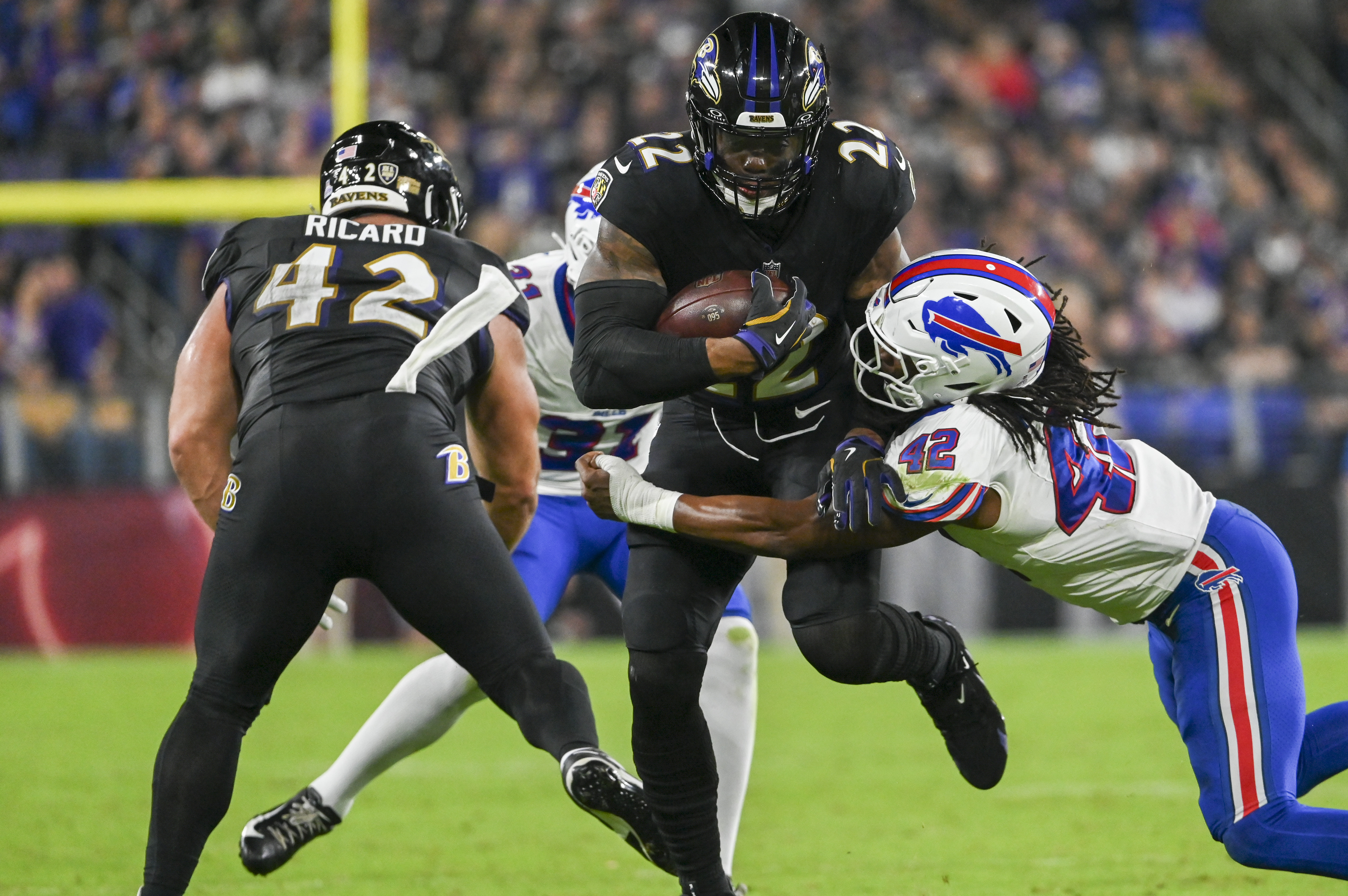 Sep 29, 2024; Baltimore, Maryland, USA; Baltimore Ravens running back Derrick Henry (22) runs through Buffalo Bills linebacker Dorian Williams (42) tackle attempt during the first half at M&T Bank Stadium.