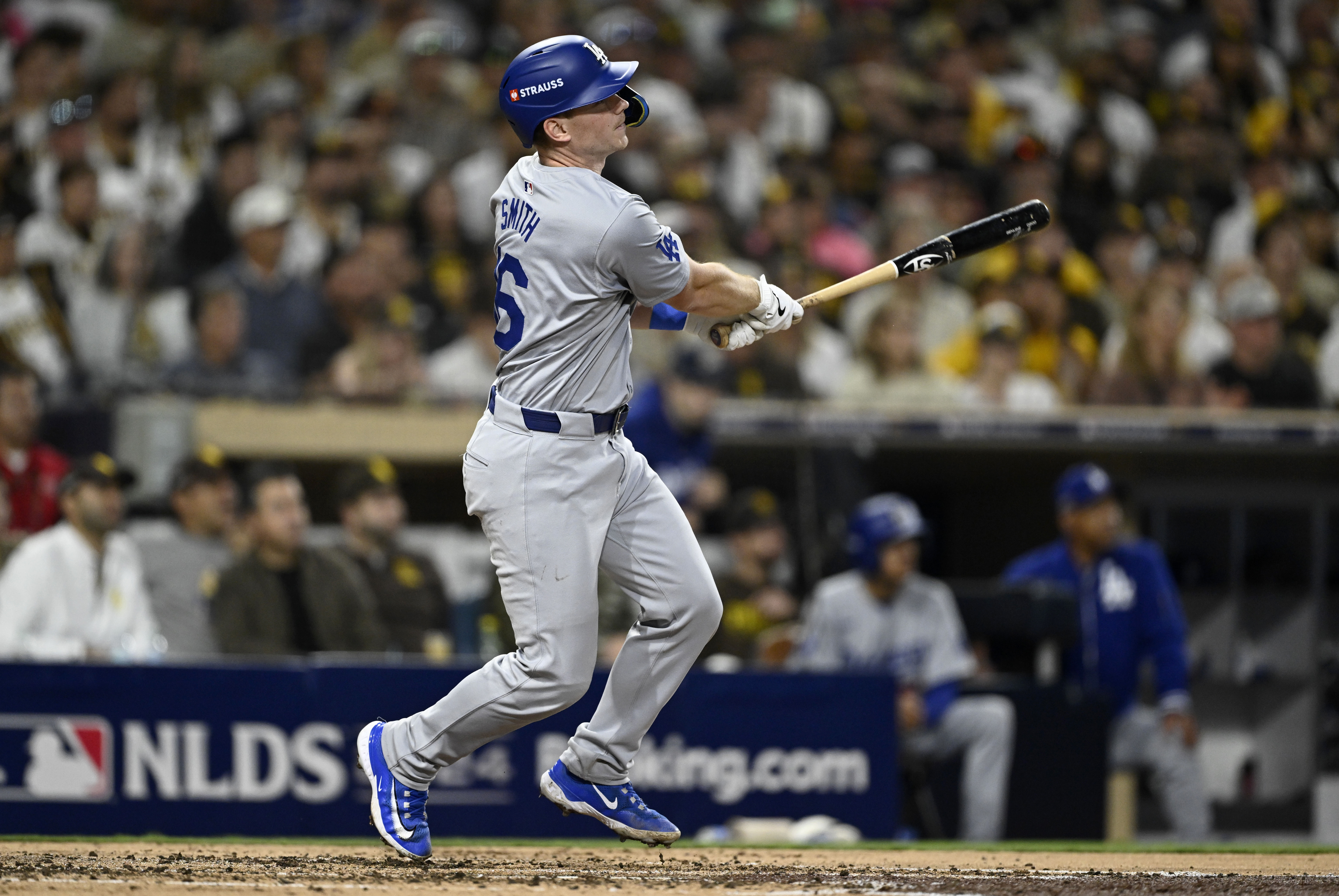 Oct 9, 2024; San Diego, California, USA; Los Angeles Dodgers catcher Will Smith (16) hits a two-run home run in the third inning against the San Diego Padres during game four of the NLDS for the 2024 MLB Playoffs at Petco Park.