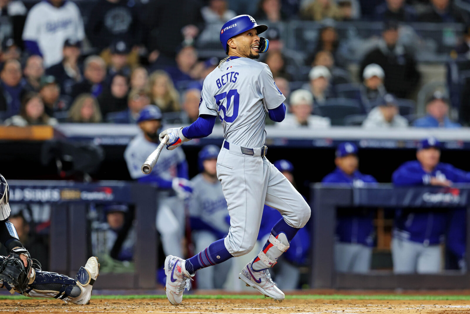 Oct 28, 2024; New York, New York, USA; Los Angeles Dodgers shortstop Mookie Betts (50) hits an RBI single during the third inning against the New York Yankees in game three of the 2024 MLB World Series at Yankee Stadium.