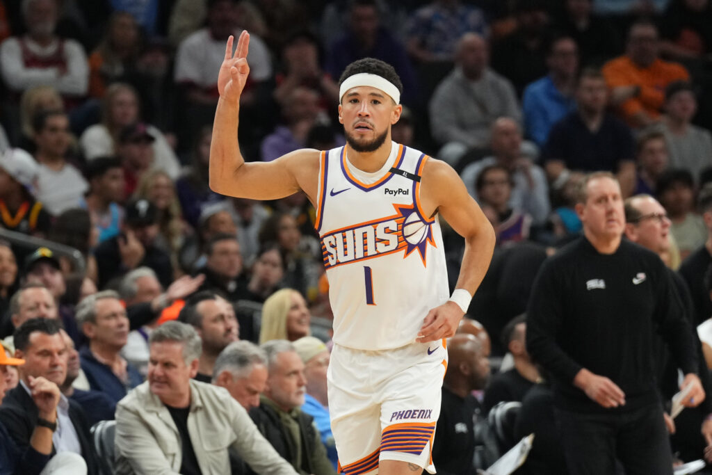 Nov 4, 2024; Phoenix, Arizona, USA; Phoenix Suns guard Devin Booker (1) reacts against the Philadelphia 76ers during the first half at Footprint Center.