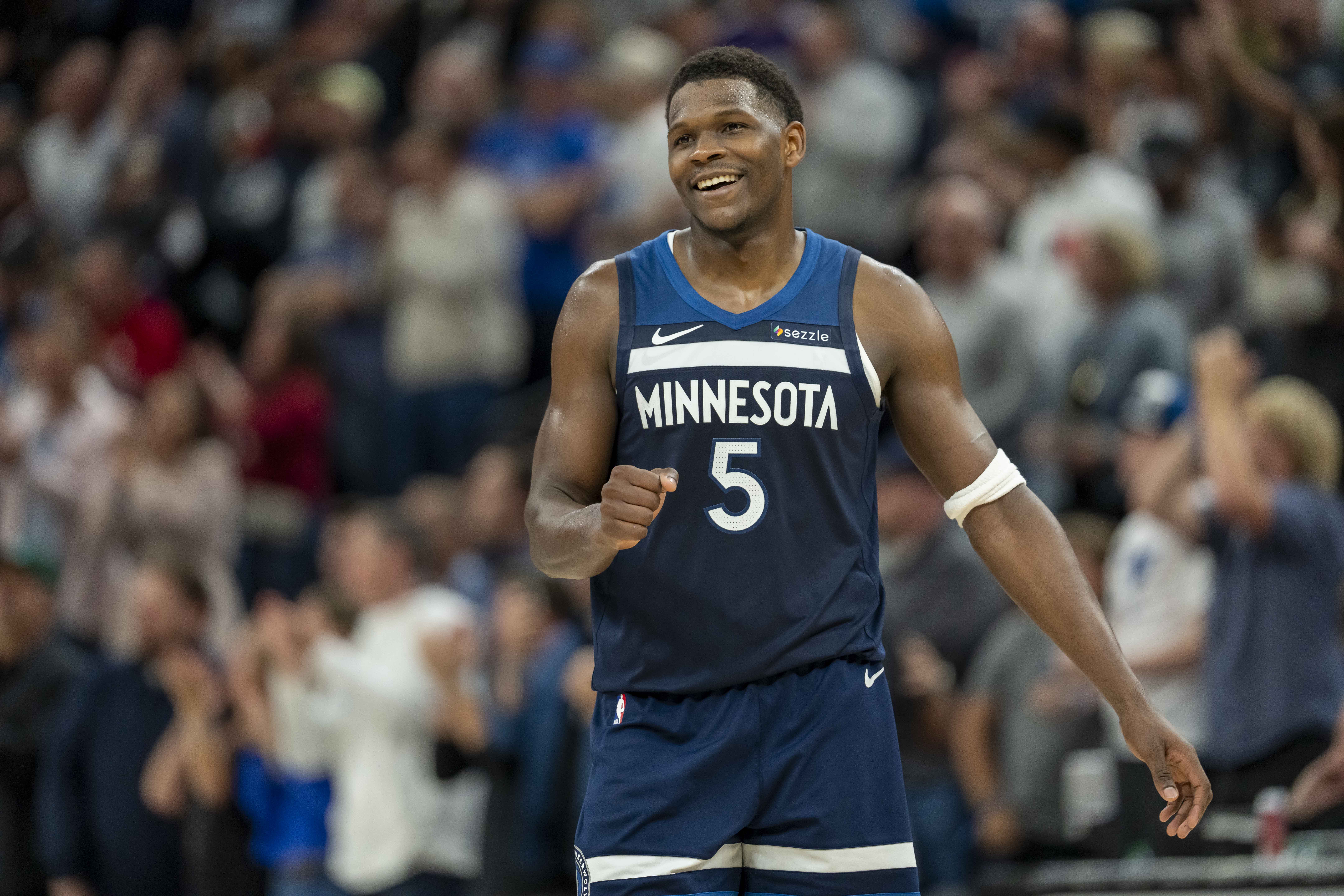 Nov 10, 2024; Minneapolis, Minnesota, USA; Minnesota Timberwolves guard Anthony Edwards (5) smiles after making a shot against the Miami Heat in the second half at Target Center.