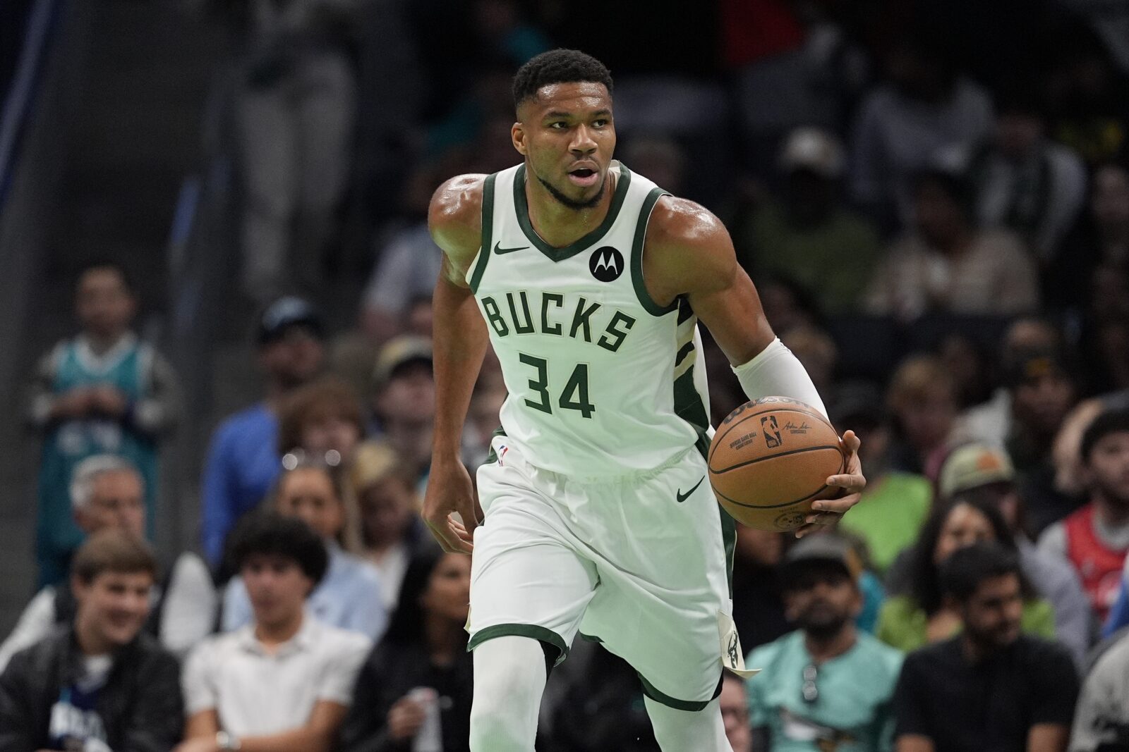 Nov 16, 2024; Charlotte, North Carolina, USA; Milwaukee Bucks forward Giannis Antetokounmpo (34) brings the ball up court against the Charlotte Hornets during the first quarter at Spectrum Center.