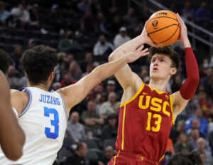 Drew Peterson #13 of the USC Trojans shoots against Johnny Juzang #3 of the UCLA Bruins during the Pac-12 Conference basketball tournament semifinals at T-Mobile Arena on March 11, 2022 in Las Vegas, Nevada